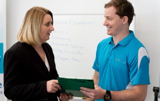 Photo of Tameka and Connor Bramwell discussing work | Featured image for Training and Development Banner.