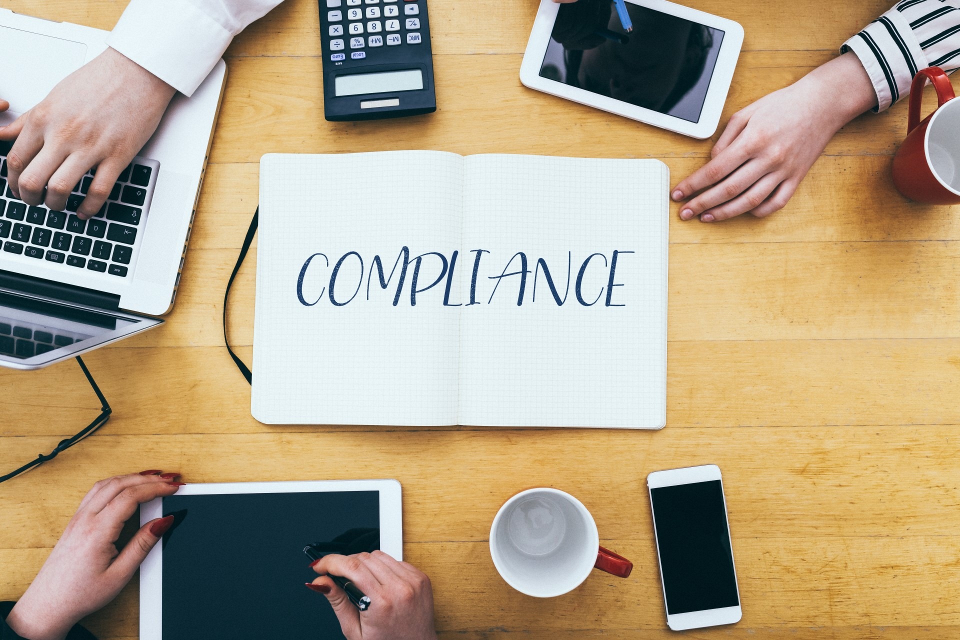 Notebook with the word compliance | Featured image for [What is HR Compliance] | Blog.